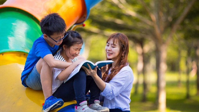 Mother and children enjoy reading time at Fun Park