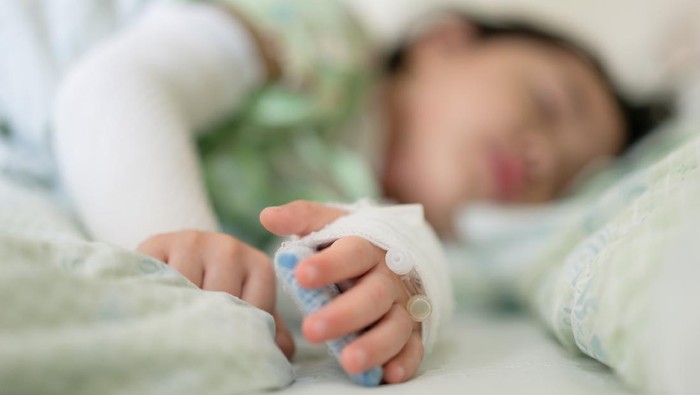 Saline intravenous (iv) drip in a Children's patient hand
