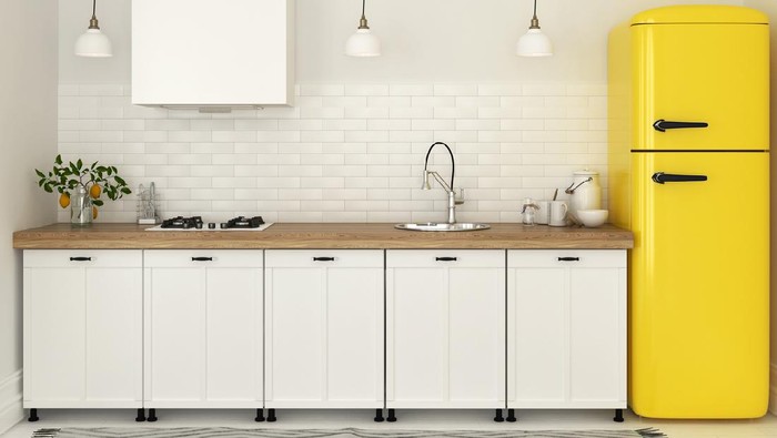 Bright kitchen with white furniture and a bright yellow fridge