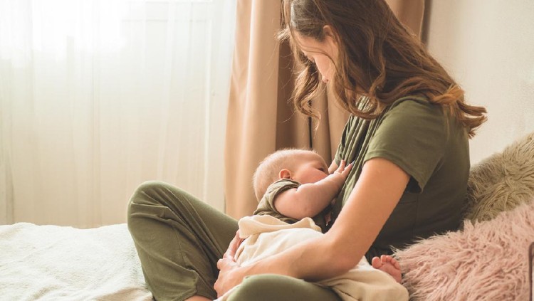happy family photo of mother and daughter breastfeeding her baby