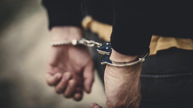 Man in handcuffs behind his back