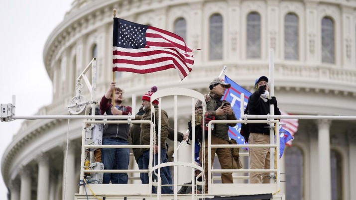 Trump supporters rally Wednesday, Jan. 6, 2021, at the Capitol in Washington. As Congress prepares to affirm President-elect Joe Biden's victory, thousands of people have gathered to show their support for President Donald Trump and his claims of election fraud. (AP Photo/Julio Cortez)