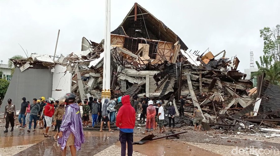 RS Mitra Manakarra Roboh Akibat Gempa Warga mengamati Gedung Kantor Gubernur Sulawesi Barat yang rusak akibat gempa bumi, di Mamuju, Sulawesi Barat, Jumat (15/1/2021). Petugas BPBD SUlawesi Barat masih mendata jumlah kerusakan dan korban akibat gempa bumi berkekuatan magnitudo 6,2 tersebut. ANTARA FOTO/Akbar Tado/wpa/hp.