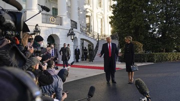 President Donald Trump and first lady Melania Trump talk to reporters as they walk to board Marine One on the South Lawn of the White House, Wednesday, Jan. 20, 2021, in Washington. Trump is en route to his Mar-a-Lago Florida Resort. (AP Photo/Alex Brandon)