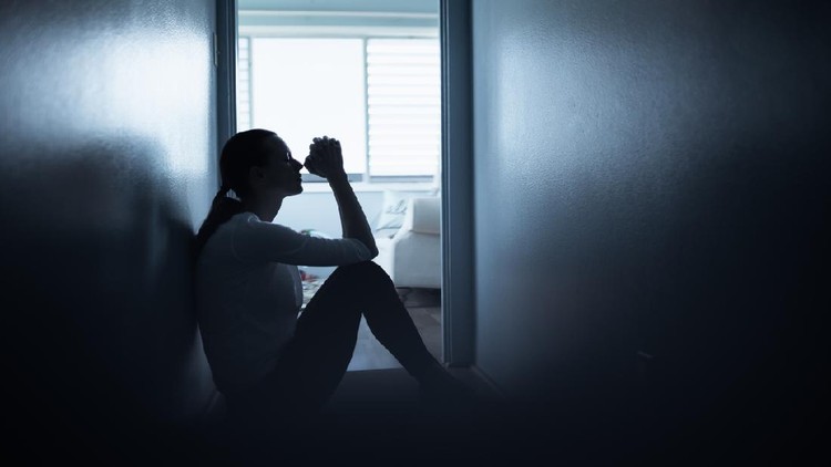 Young woman at home feeling desperate saying a prayer.