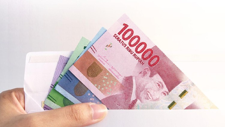 woman hand showing envelope and Indonesia rupiah money