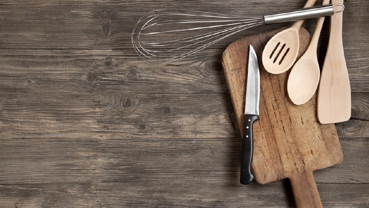 Kitchen utensils on an old wooden background