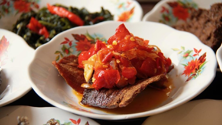 Dendeng Balado, a popular dish of crispy beef jerky topped with lightly crushed red chili pepper from Minangkabau cuisine, West Sumatra. The dish is part of the many dishes served in a Minang eatery.