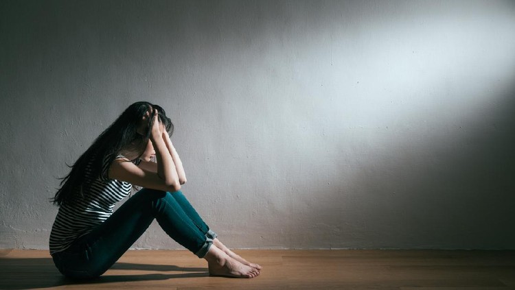 Anxiety disorder menopause woman, stressful depressed, panic attack person with mental health illness, headache and migraine sitting with back against wall on the floor in domestic home