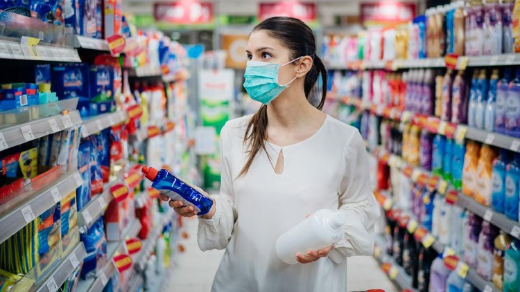 Woman wearing protective mask preparing for virus pandemic spread quarantine.Hygiene, cleaning and disinfection products.Preventive measures and protection.Supply shopping during the epidemic.