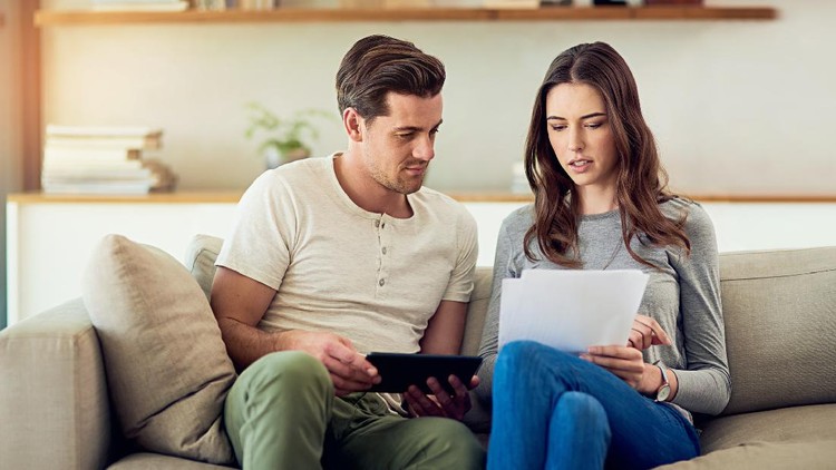 Shot of a young couple going through their paperwork together at home