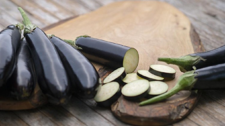 Organic eggplants on wood background