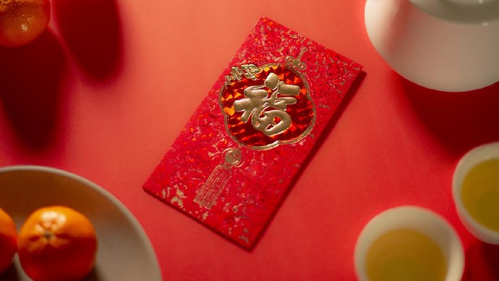 Chinese new year food and drink still life with red envelope Ang Pao.