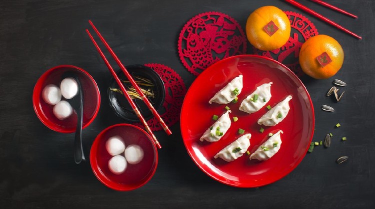 Flat lay Chinese new year food and drink still life. Texts appear in image: Prosperity, spring, good luck.