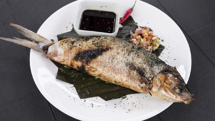 Grilled Boneless Bangus stuffed with vegetables and served with soysauce and Atchara. Bangus is also known as Milkfish.