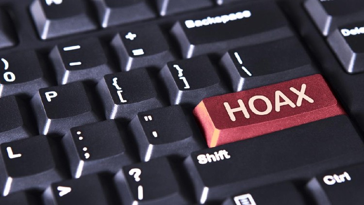 Close up of a computer keyboard with word of hoax on the red button