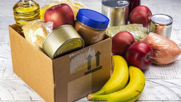 Food sharing concept. Fighting with overconsumption background. Various products in a food donation box
