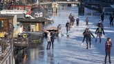 FOTO: Pemandangan Kanal di Belanda yang Membeku Kanal Prinsengracht di Amsterdam, Belanda, sempat membeku pada pertengah Februari. Warga langsung berdatangan untuk main ice skating.