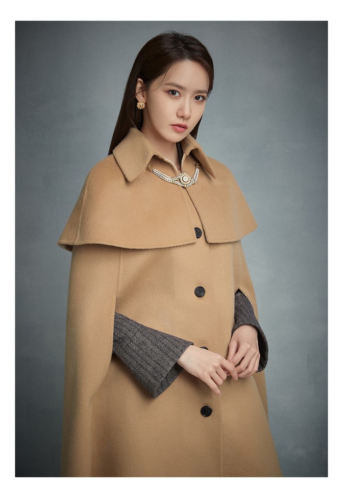 Masih berkonsep winter, Yoona tampil mewah dan elegan dengan gaun wol herringbone dan mantel jubah berwarna coklat. (Foto: jigott.co.kr)