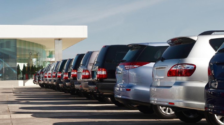 Membeli Mobil New cars at dealer showroom. Themed blur background with bokeh effect. Car auto dealership. Prestigious vehicles.