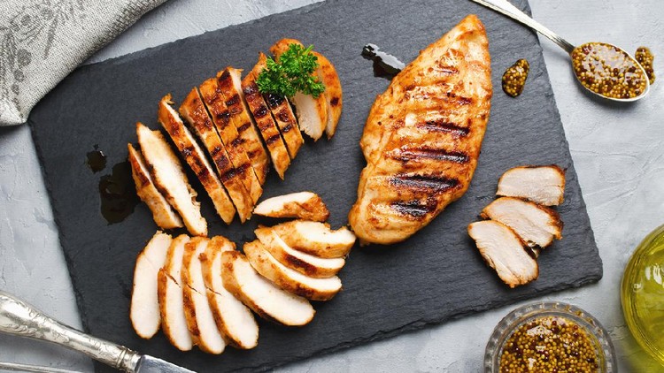 Ilustrasi Dada Ayam Grilled chicken fillets on slate plate. Gray concrete background
