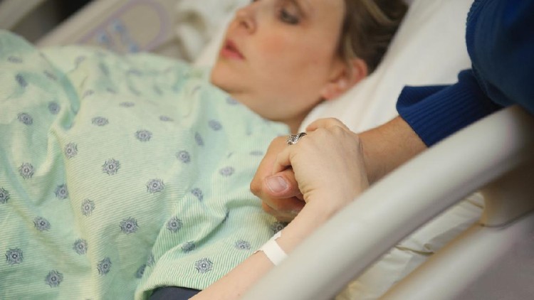 Young Pregnant woman getting ready for Natural Childbirth while lying in her hospital bed