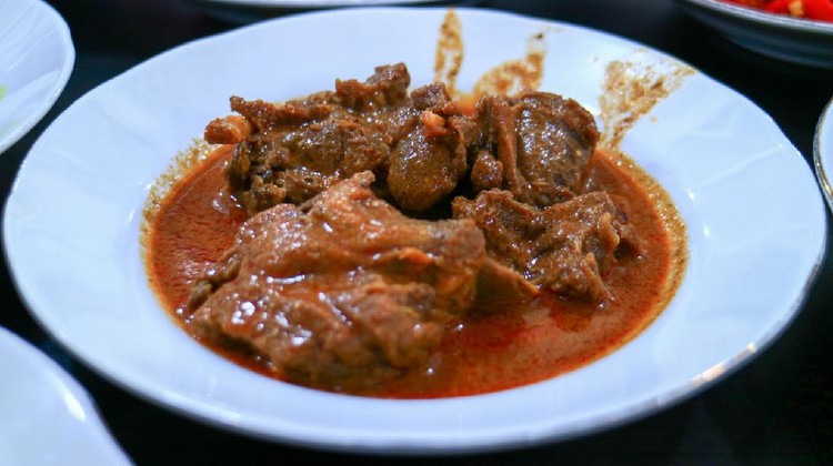 Lamb curry Padang style (gulai cincang) on plate at Padang Restaurant in Jakarta, Indonesia.
