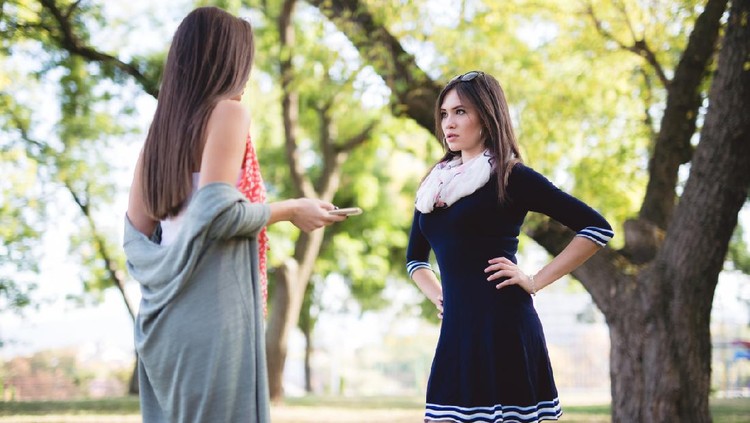 Two female friends having disagreement in a park
