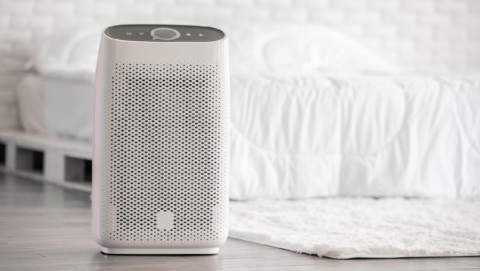Air purifier in cozy white bed room for filter and cleaning removing dust PM2.5 HEPA in home,for fresh air and healthy life,Air Pollution Concept