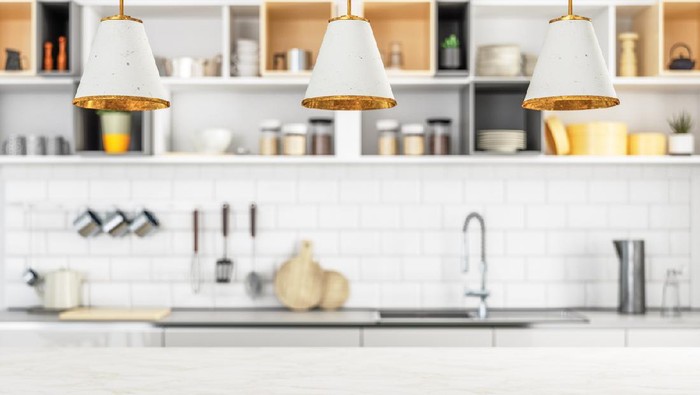 small kitchen in a pool guest house with appliances and cabinets and a counter and custom lighting