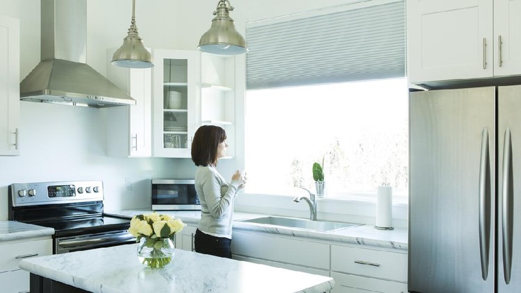 small kitchen in a pool guest house with appliances and cabinets and a counter and custom lighting