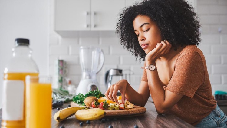Shot of a young woman looking unhappy while making a healthy snack with fruit at home