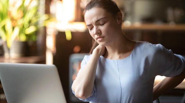 Stressed upset business woman feeling backpain working on laptop sitting in incorrect posture, tired fatigued student rub back suffer from spine muscular pain injury lumbar backache concept in office