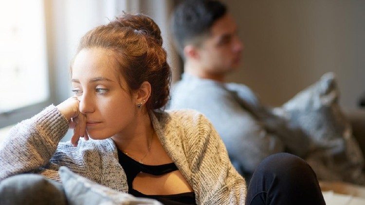 Shot of a young woman looking despondent after a fight with her boyfriend