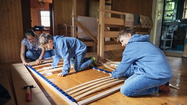 Brothers and sister assembling bed base together.



Nikon D850