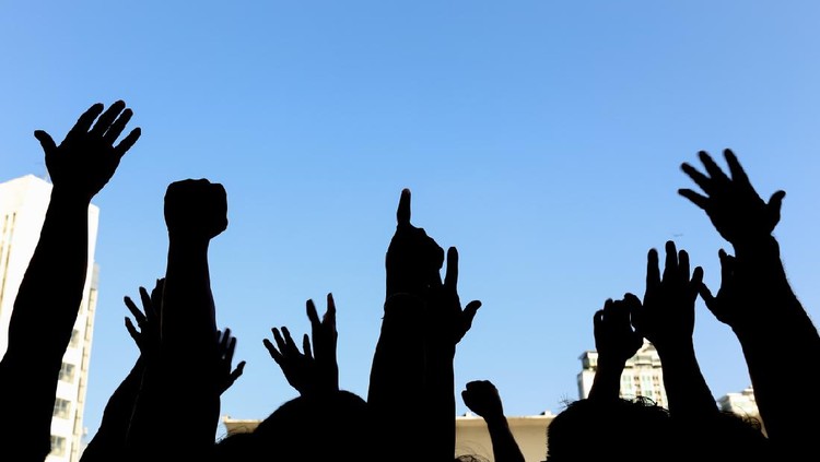 community initiative or concert concept, hands of group of people in the sky, silhouette