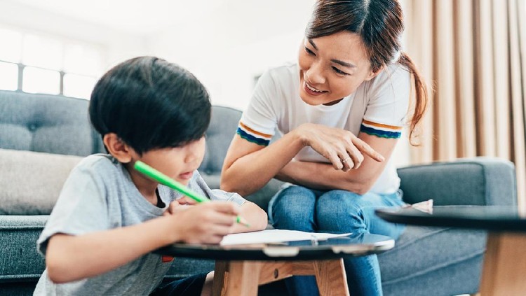 Young mother teaching her son
