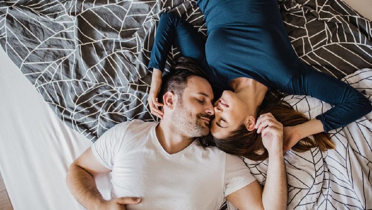 Young couple is hugging in bed in the morning