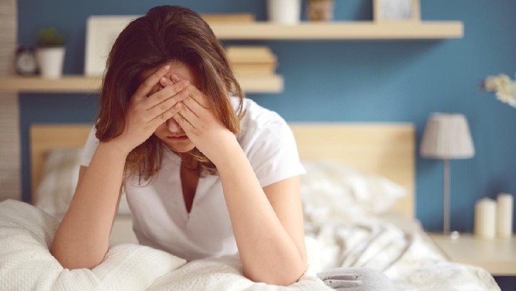 Unhappy girl in a bedroom