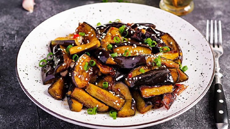 Hot spicy stew eggplant in Korean style with green onion. Aubergine saute. Vegan food.