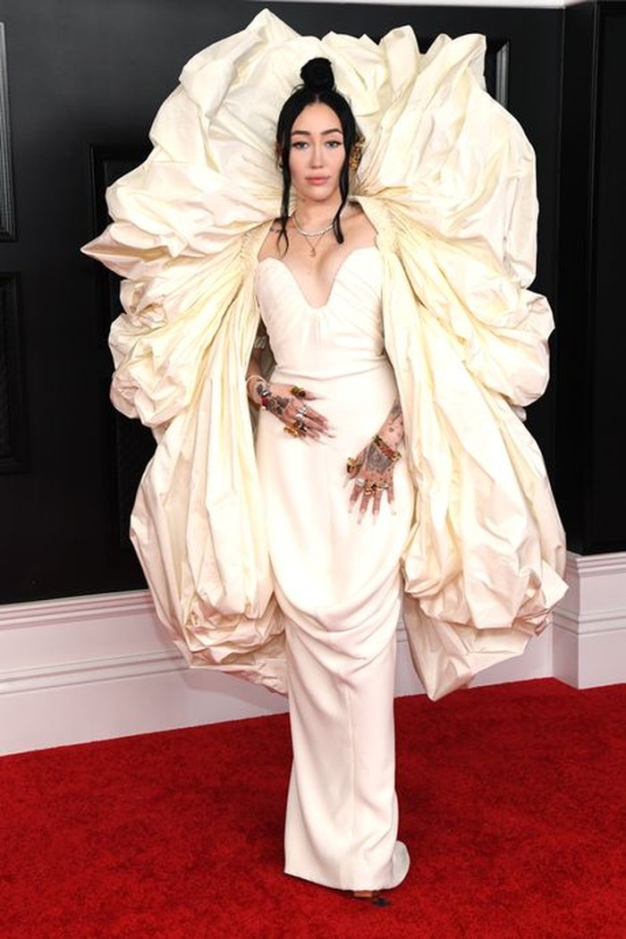 Noah Cyrus menggemparkan red carpet dengan gaunnya yang lebar dengan sayap bak malaikat berwarna putih. Dia memakai gaun koleksi Schiaparelli's Haute Couture Spring Summer 2021 Collection/Sumber/LA Times.