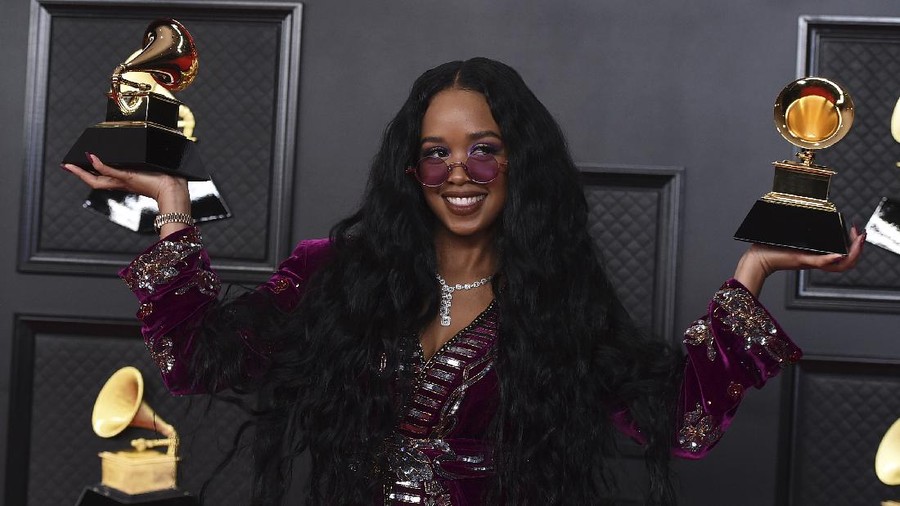 H.E.R. poses in the press room with the award for song of the year for 