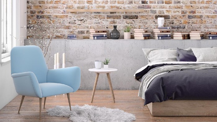 Bedroom interior with large bed, modern nightstand and wall lamp, armchair, many books around, plant, blank wall. Copy space template