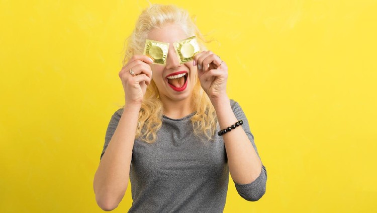 Woman holding condoms