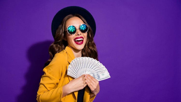 Portrait of her she nice lovely cheerful cheery glad rich wealthy wavy-haired, lady holding in hands large budget sum grant lottery win isolated over bright vivid shine violet lilac background