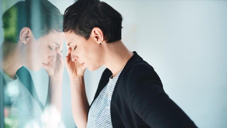 Shot of a young businesswoman looking stressed out in an office