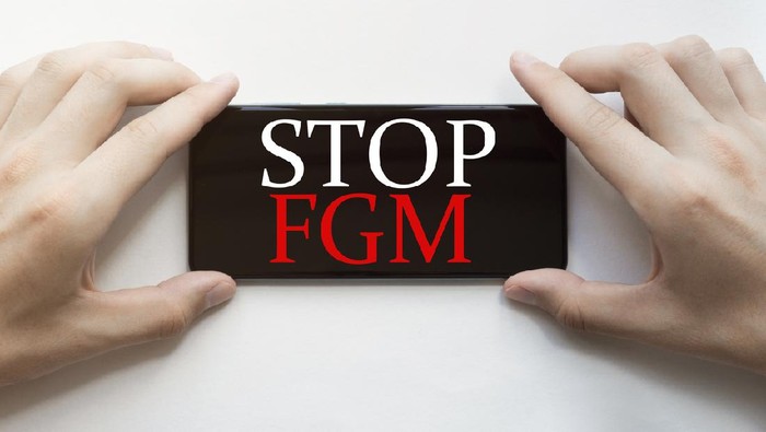 white paper with text Stop Fgm with clothespins on white background