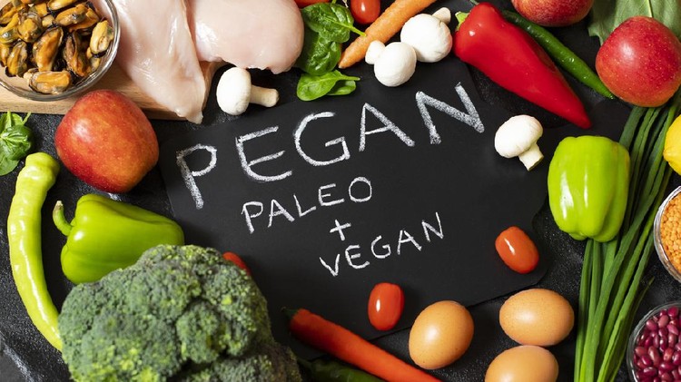 Pegan diet. Combination of vegan and paleo diets. Healthy food - assortment of fresh vegetables and fruits, chicken, eggs, mussels, legumes, mushrooms. Dark background