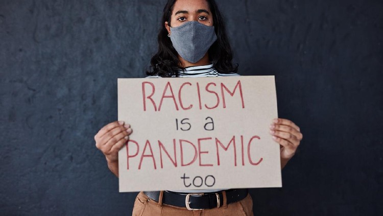 Kampanye Anti Rasisme, Stop Asian Hate A man holding Racism is a Virus sign
