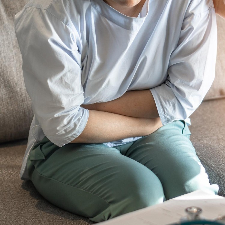 Abdominal pain patient woman having medical exam with doctor on illness from stomach cancer, irritable bowel syndrome, pelvic discomfort, Indigestion, Diarrhea, GERD (gastro-esophageal reflux disease)